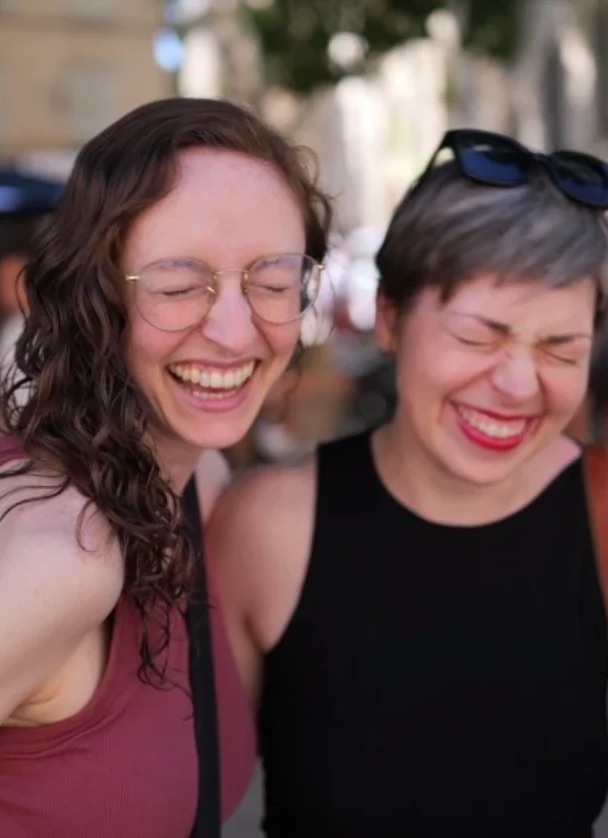 Two women laughing together outdoors